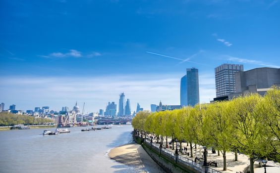 A view along the River Thames on a sunny day in London, UK.