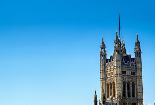 British Parliament along the River Thames on a sunny day in London, UK.