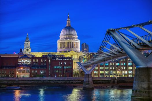 St. Paul's Cathedral across Millennium Bridge and the River Thames in London, UK.