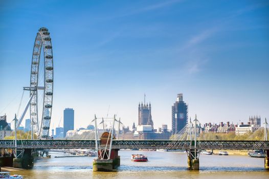 A view along the River Thames on a sunny day in London, UK.