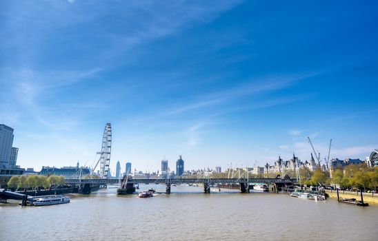 A view along the River Thames on a sunny day in London, UK.