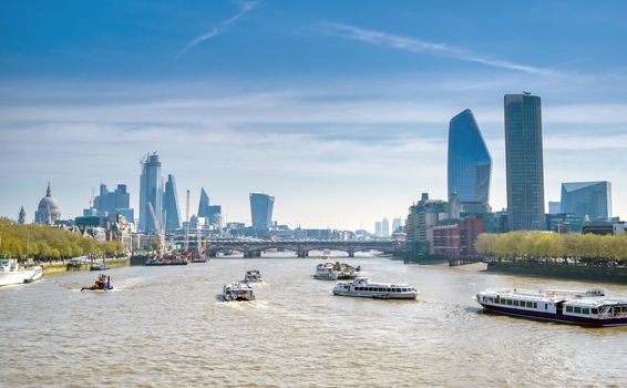 A view along the River Thames on a sunny day in London, UK.