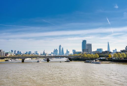 A view along the River Thames on a sunny day in London, UK.