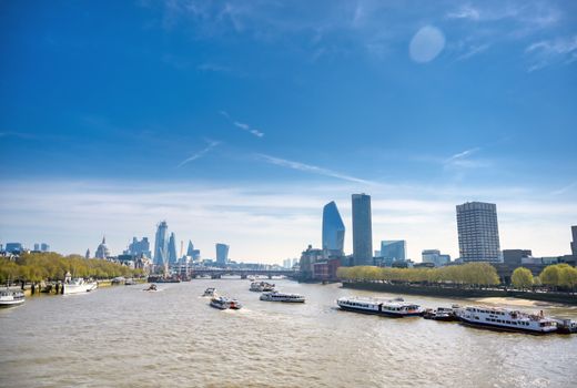 A view along the River Thames on a sunny day in London, UK.