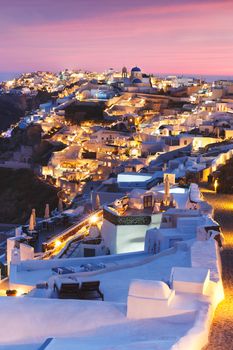 Unique view for the sunset over Oia, Santorini, a small, beautiful village on the edge of the caldera, Greece