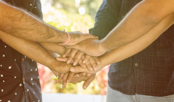 Concept of Friendship, support and teamwork People joining hands together - Young people holding hands together at outdoor