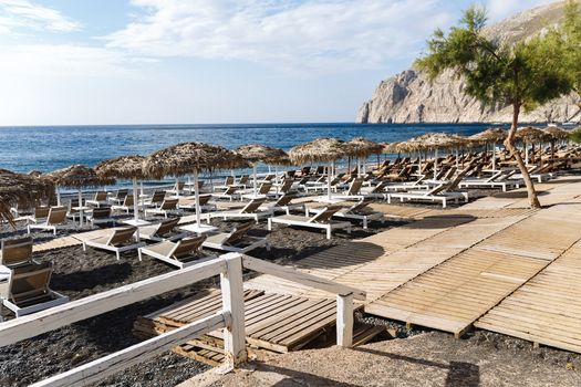 Kamari Beach, Santorini. Volcanic sand beach and mountain of Kamari beach, Santorini, Greece