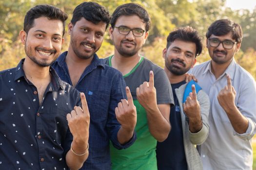 Group of Young Indian Voters showing fingers after casting there votes