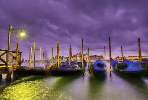 Gondolas moored by Saint Mark square on the Grand canal at dawn in Venice, Italy, Europe. Long exposure.