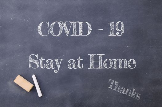 Coronavirus pandemic behaviour rules or health advice. Covid-19 Stay at Home chalkboard inscription.