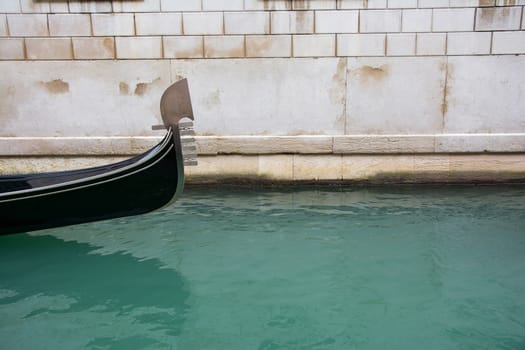 Gondola sailing through a canal in Venice, Italy.