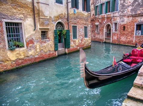 Gondola sailing through a canal in Venice, Italy.