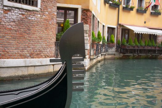 Gondola sailing through a canal in Venice, Italy.