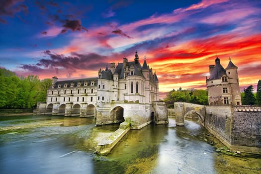 Chenonceau, France - April 16, 2019: Medieval castle in Chenonceaux, France. Beautiful Chateau de Chenonceau at dusk over the river Cher, Loire Valley, France.