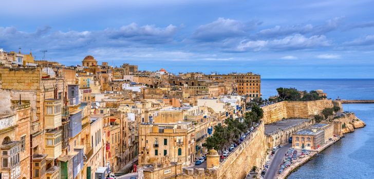 La Valletta, Malta - January 8, 2020: Valletta with traditional Maltese buildings with colorful shutters and balconies in the sunny day, Valletta, Capital city of Malta