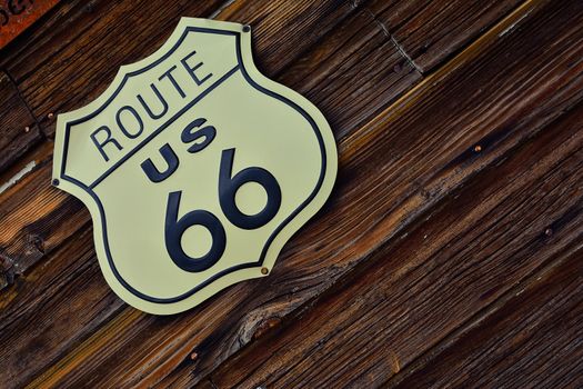 Historic U.S. old Route 66 sign with wooden background.