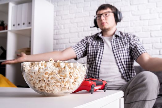 Stay home. Disappointed young man playing video games at home. Selective focus