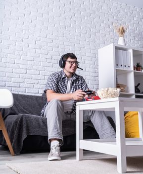 Stay home. Excited young man playing video games at home enjoying his victory