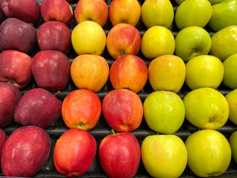 A bin of stacks of apples at a grocery store.