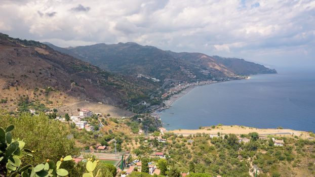 Panoramic view of Sicilian coast with Letojanni town from Taormina, Italy