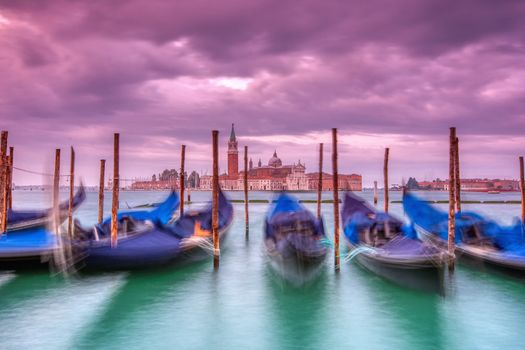 Gondolas moored by Saint Mark square on the Grand canals at dawn in Venice, Italy, Europe. Long exposure.