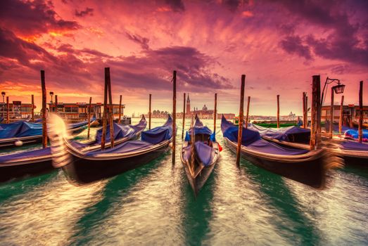 Gondolas moored by Saint Mark square on the Grand canals at dawn in Venice, Italy, Europe. Long exposure.