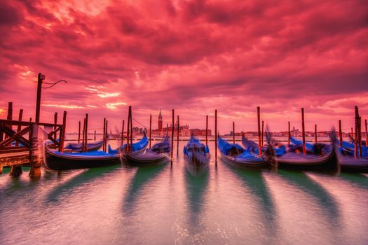 Gondolas moored by Saint Mark square on the Grand canal at dawn in Venice, Italy, Europe. Long exposure.