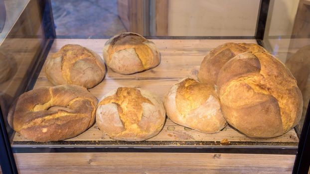 Fresh bread and buns laying on a shop shelf