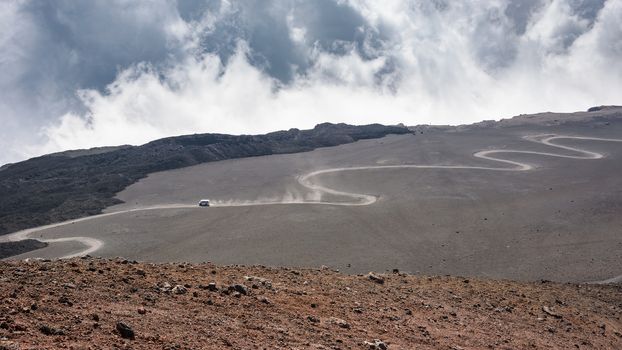 Road on the lava field to the top of Mount Etna, Sicily, Italy