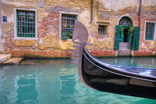 Gondola sailing through a canal in Venice, Italy.