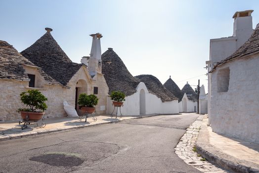 View of street in Alberobello town with famous trulli houses, Italy