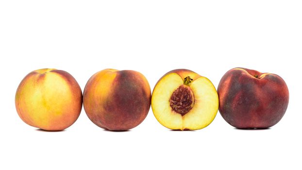 Ripe peaches in a row isolated on white background with clipping path