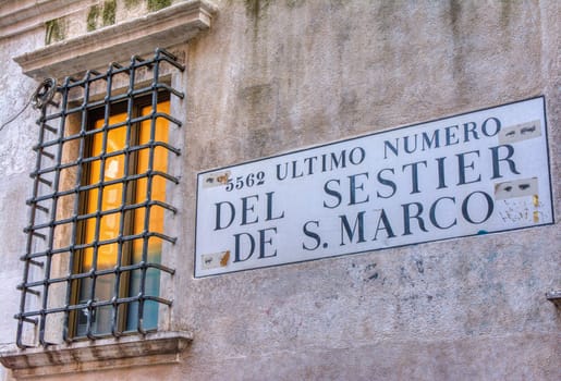 Venice, Italy - October 13, 2019: Road sign with text 5562 Ultimo numero del Sestier de San Marco in italian language.