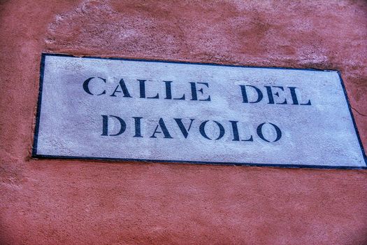 Venice, Italy - October 13, 2019: Road sign with text Calle del Diavolo that means street of the Devil in italian language.