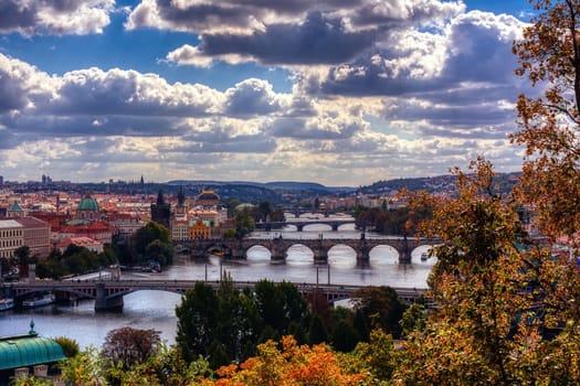 Charles bridge, Karluv most and Lesser town tower, Prague in autumn at sunrise, Czech Republic.