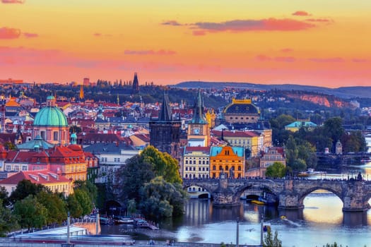 Charles bridge, Karluv most and Lesser town tower, Prague in autumn at sunrise, Czech Republic.