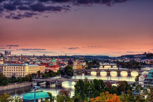 Charles bridge, Karluv most and Lesser town tower, Prague in autumn at sunrise, Czech Republic.