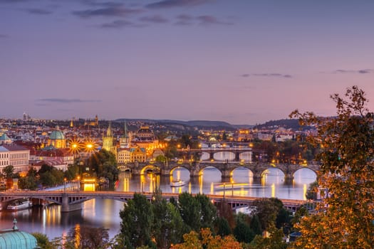 Charles bridge, Karluv most and Lesser town tower, Prague in autumn at sunset, Czech Republic.