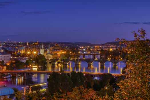 Charles bridge, Karluv most and Lesser town tower, Prague in autumn at sunrise, Czech Republic.