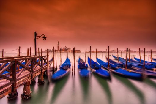 Gondolas moored by Saint Mark square on the Grand canals at dawn in Venice, Italy, Europe. Long exposure.