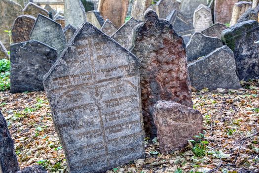 Prague, Czech Republic - September 26, 2018: Tombstones on Old Jewish Cemetery in the Jewish Quarter in Prague.There are about 12000 tombstones presently visible. One of the most important Jewish monument.