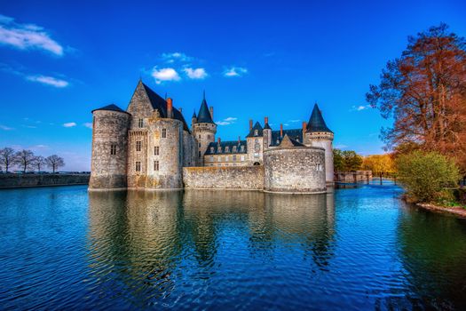 Sully Sur Loire, France - April 13, 2019: Famous medieval castle Sully sur Loire at sunset, Loire valley, France. The chateau Sully sur Loire dates from the end of the 14th century and is a prime example of medieval fortress.