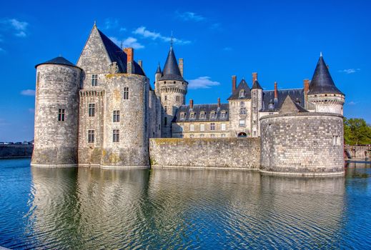 Sully Sur Loire, France - April 13, 2019: Famous medieval castle Sully sur Loire at sunset, Loire valley, France. The chateau Sully sur Loire dates from the end of the 14th century and is a prime example of medieval fortress.