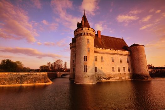 Sully Sur Loire, France - April 13, 2019: Famous medieval castle Sully sur Loire at sunrise, Loire valley, France. The chateau of Sully sur Loire dates from the end of the 14th century.