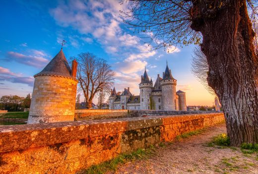 Sully Sur Loire, France - April 13, 2019: Famous medieval castle Sully sur Loire at sunset, Loire valley, France. The chateau dates from the end of the 14th century.