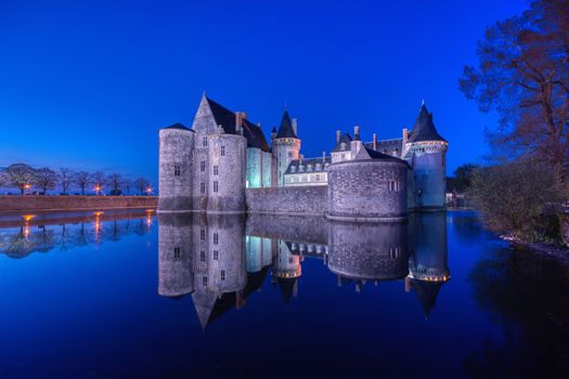 Sully Sur Loire, France - April 13, 2019: Famous medieval castle Sully sur Loire at night, Loire valley, France. The chateau of Sully sur Loire dates from the end of the 14th century and is a prime example of medieval fortress. Blue hour.