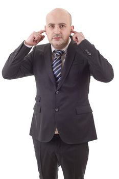 handsome business man covering his ears ignoring noise, isolated