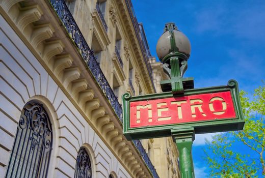 Paris, France - April 21, 2019 - A sign that marks the entrance to a metro station for the Paris underground subway system in France. 