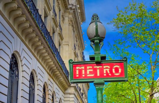 Paris, France - April 21, 2019 - A sign that marks the entrance to a metro station for the Paris underground subway system in France. 