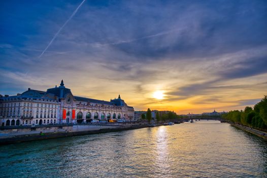 Paris, France - April 21, 2019 - A view of the Musee d'Orsay along the River Seine at sunset in Paris, France.